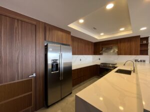 The refrigerator is seamlessly built into the cabinetry