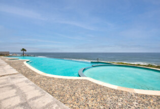 Enjoy the warm sunny days in the outdoor pool. Palacio del Mar, Luxury Condos, Villas & Spa in Rosarito Beach